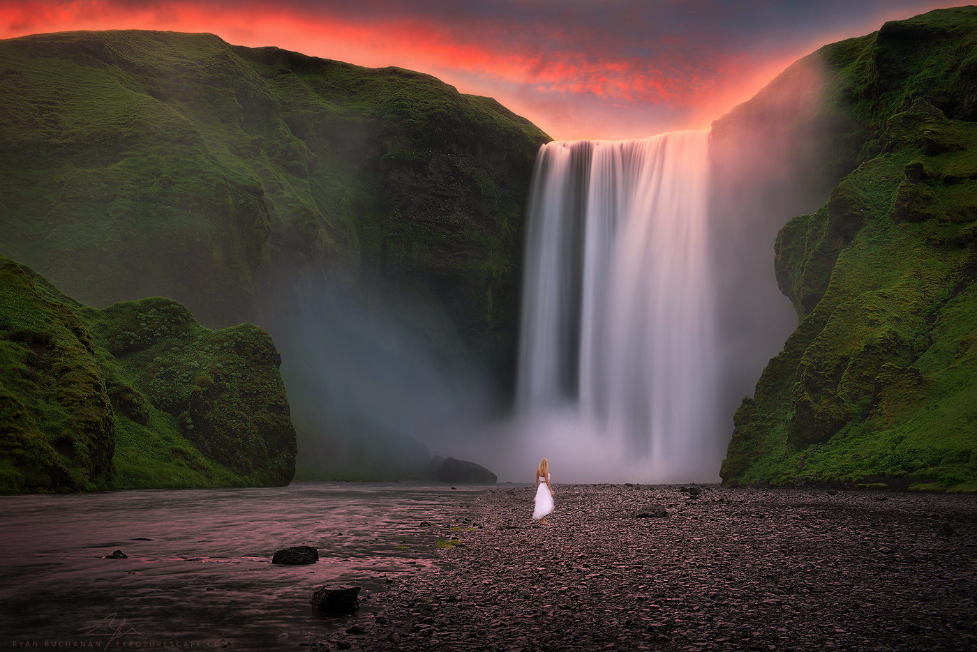woman standing in front of skogafoss waterfall in iceland